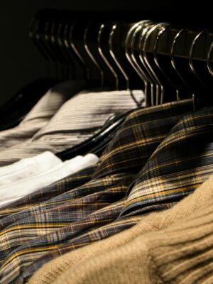 Organized display of various shirts on hangers, showcasing fashion and style.